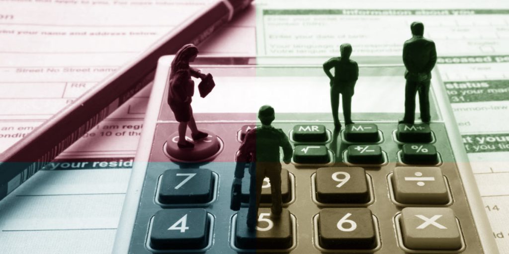Accountancy services - accountants stood on calculator